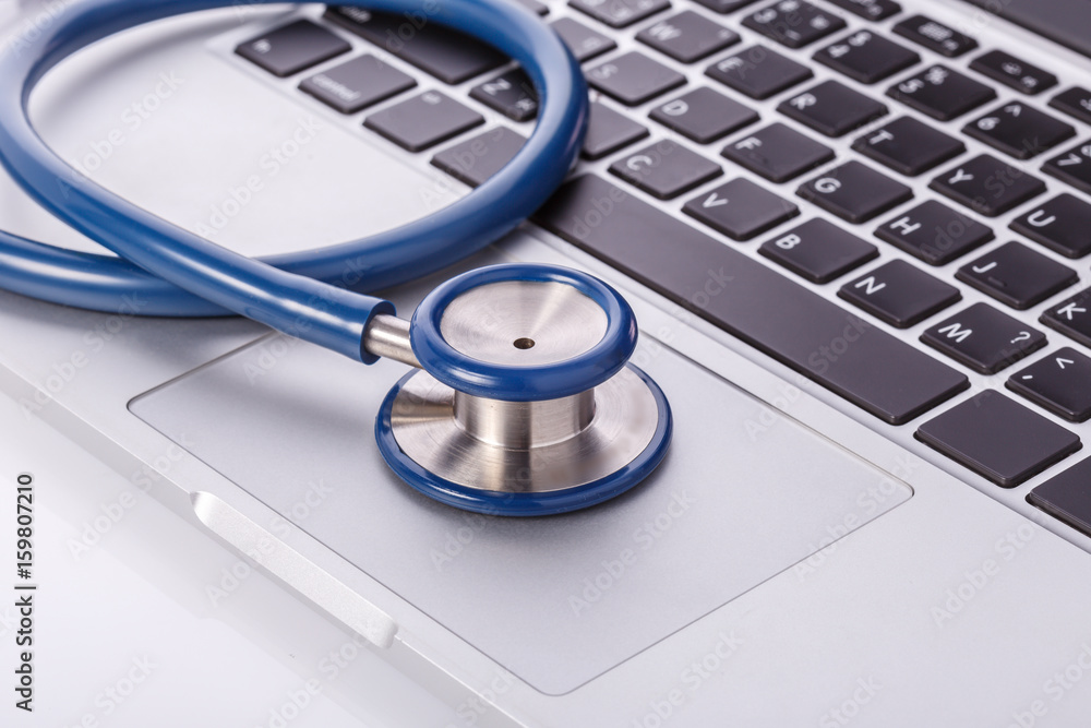 Computer notebook or laptop and stethoscope. Checking virus or damaged check up concept. Computer notebook or laptop and stethoscope. Checking virus or damaged check up concept.