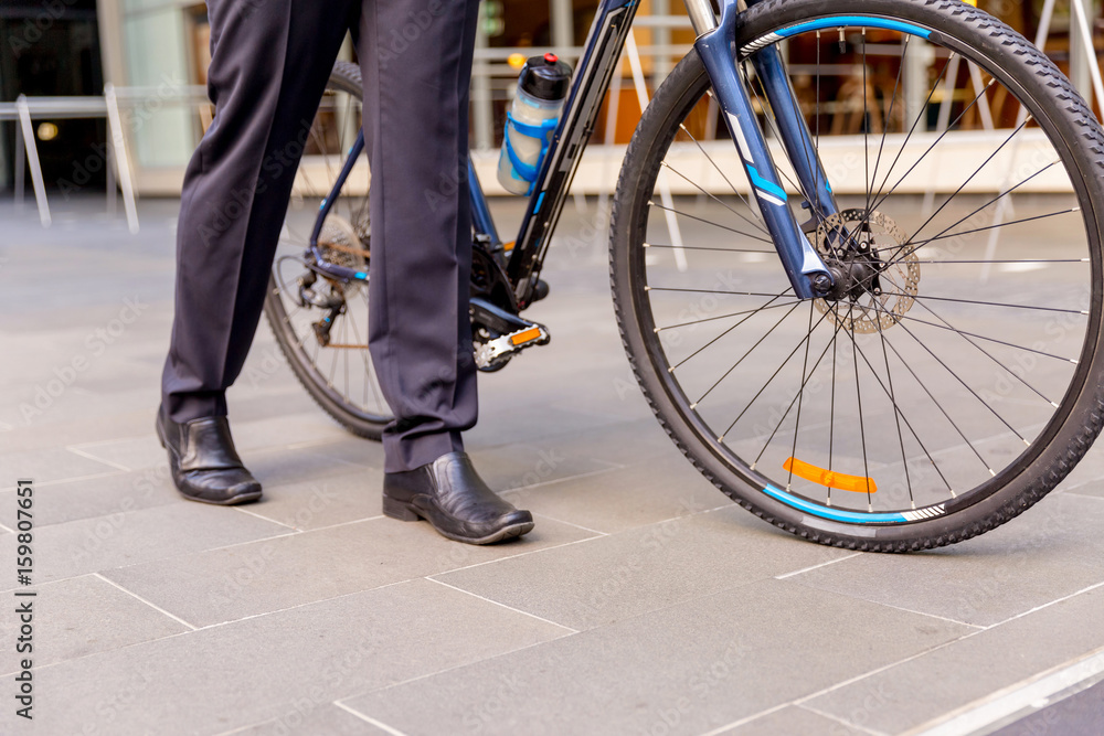 Successful businessman riding bicycle Successful businessman riding bicycle