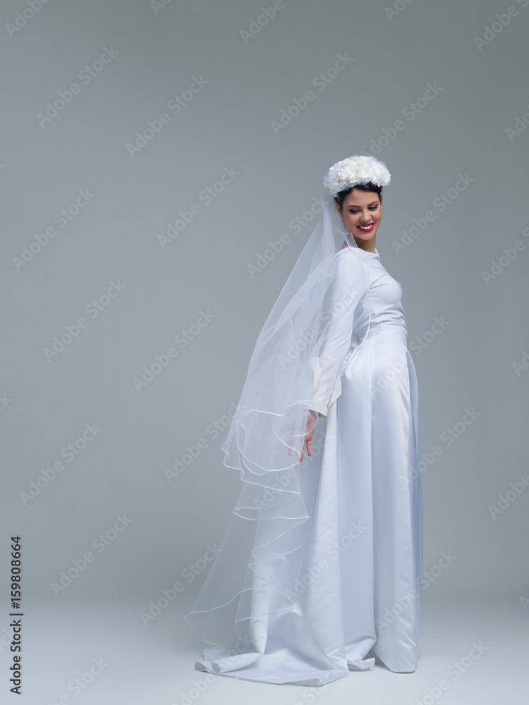 young bride in a wedding dress with a veil young bride in a wedding dress with a veil