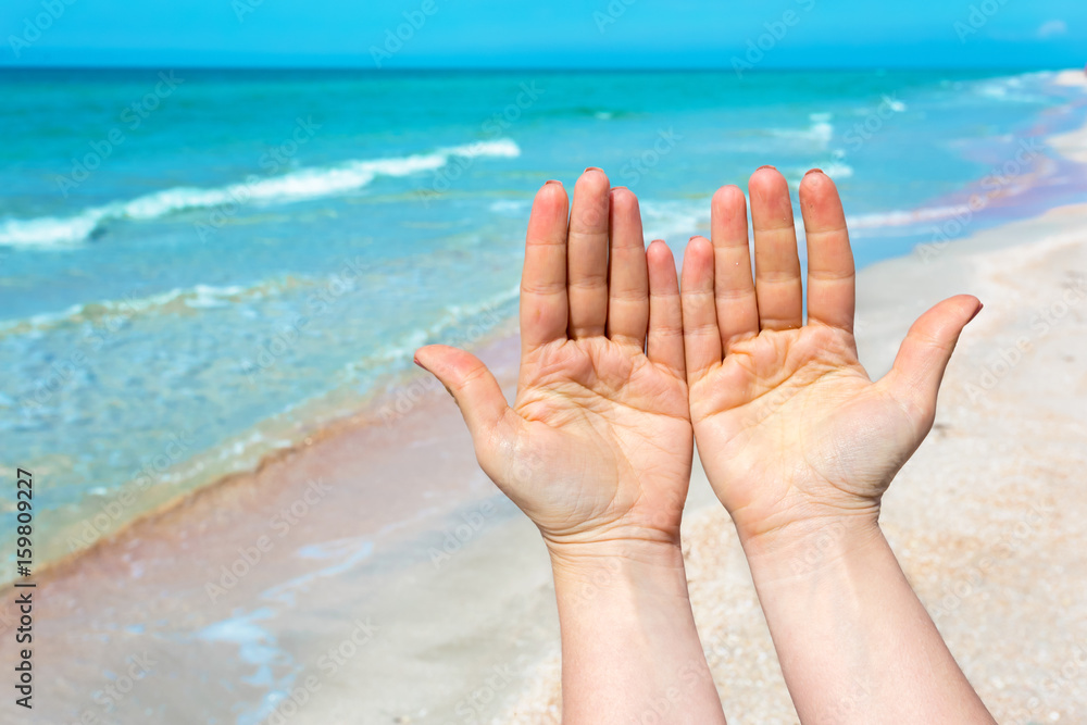 hand sign over blue sea and sky background, summer travel, holiday vacation concept background