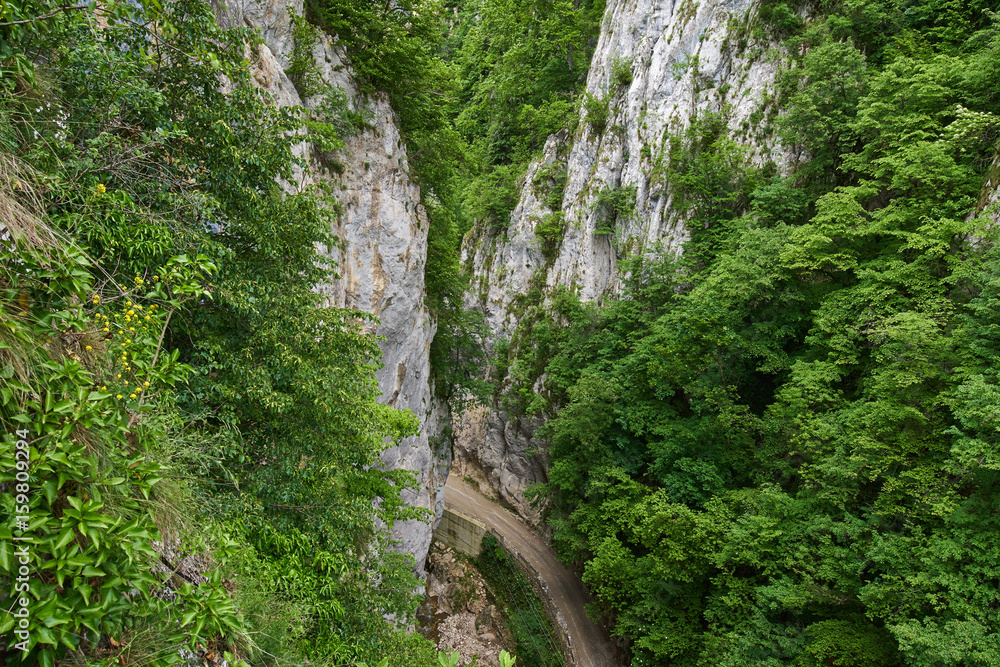 Mountain gravel road through canyon