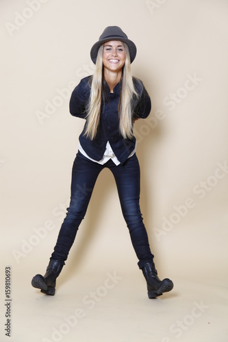 Beautiful young woman, with long blond hair and blue eyes. Young pretty woman, with black hat