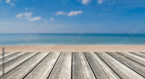 Wood table top and blurred summer blue sea and sky background. - can used for display or montage your products.