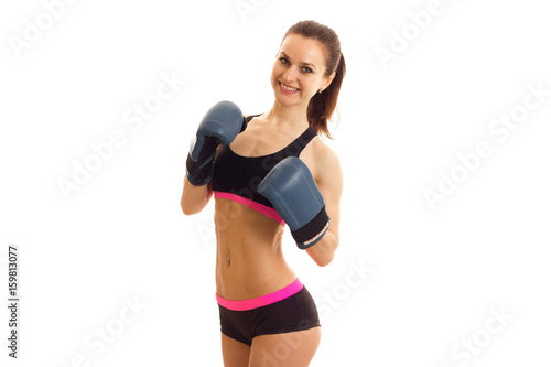stunning young sportswoman smiles for the camera in boxing gloves © ponomarencko