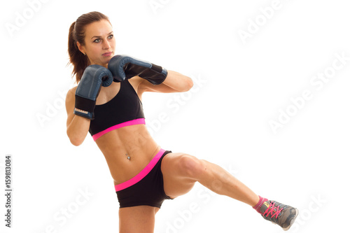 a young athlete with beautiful body raised leg and boxes