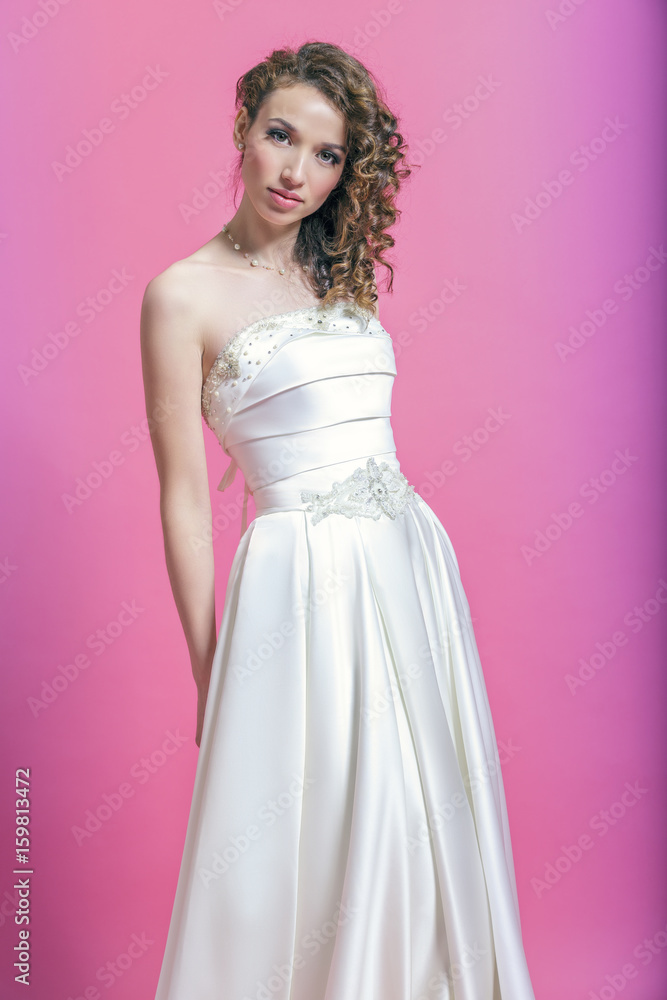 Beautiful girl in white satin dress. Beautiful girl in white satin dress.
