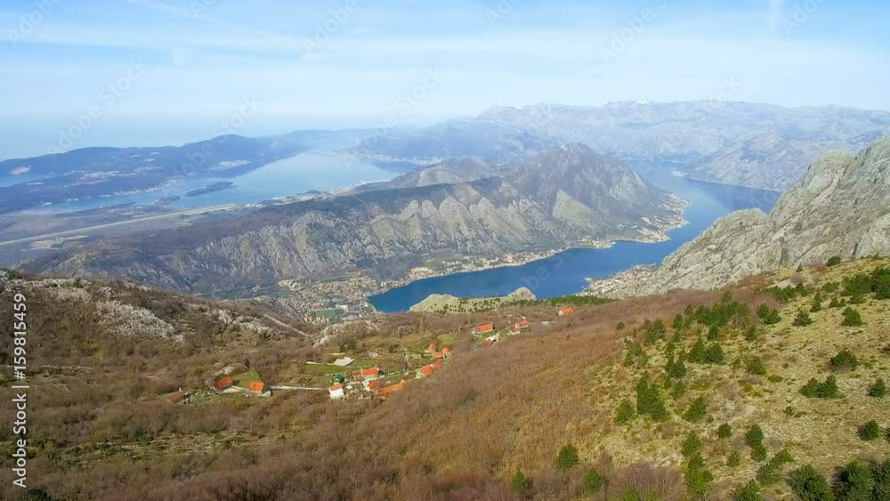 Mountains, bay and houses with red roofs in sunny day aerial view Mountains, bay and houses with red roofs in sunny day aerial view