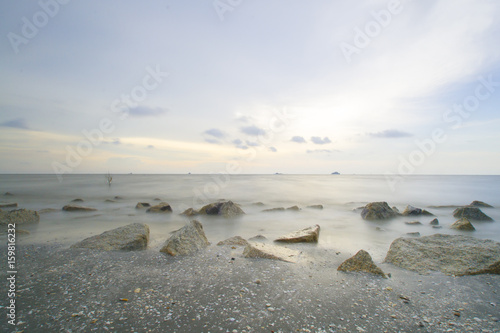 Scenery of sunset captured at Pantai Remis, Selangor, Malaysia. The motion of cloud and water is due to long exposure effect. Low light
