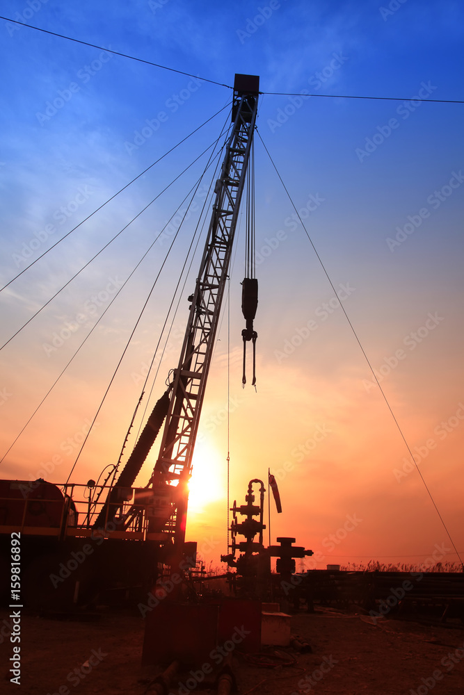 In the evening, the silhouette of oilfield derrick In the evening, the silhouette of oilfield derrick