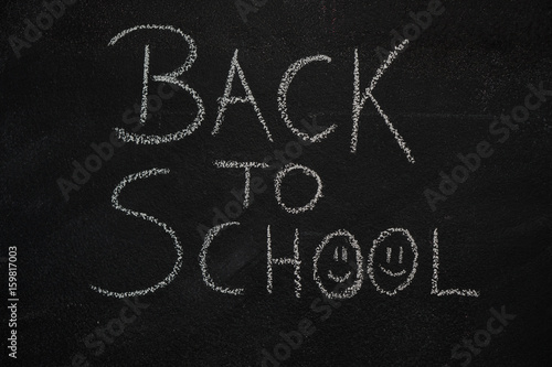 Back to school text written with chalk on blackboard. Education  school concept