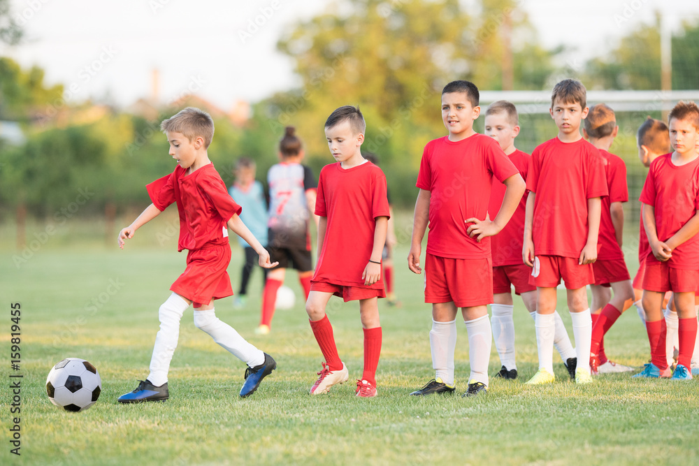 Kids soccer football - children players match on soccer field