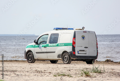 police car drives along the sea, latvia