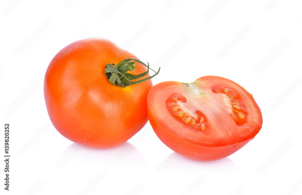 whole and portion cut fresh tomato on white background