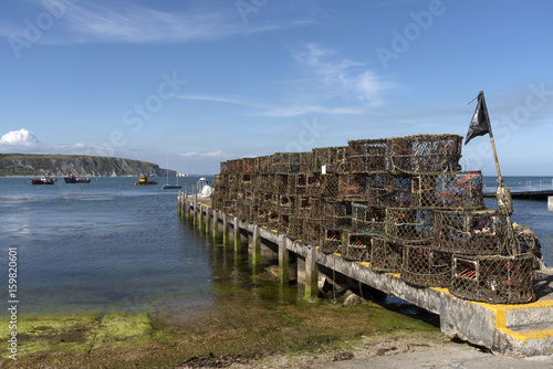 Crab and lobster pots on the quayside on Swanage Bay Dorset England UK