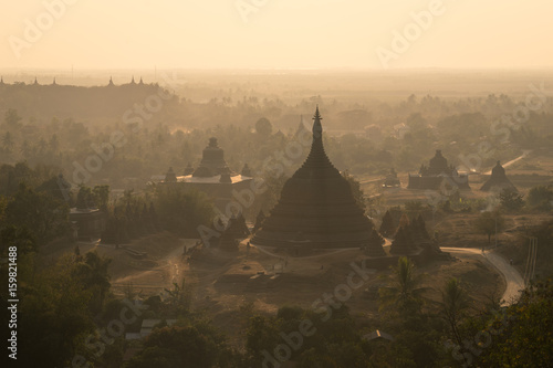 Pagodas and monastery on hill at sunset, north Mrauk U, Rakhine state, Myanmar