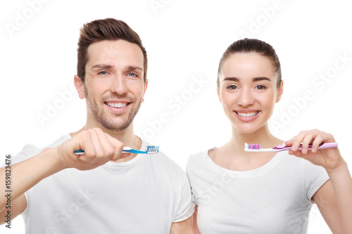 Young happy couple brushing...