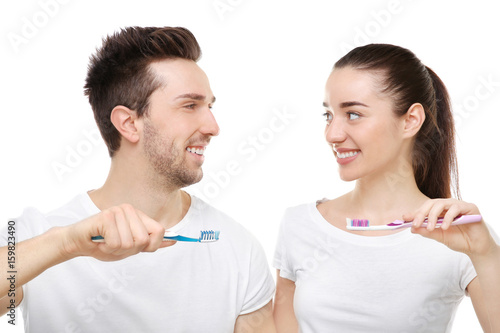 Young happy couple brushing...