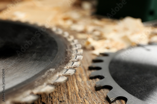 Fototapeta Naklejka Na Ścianę i Meble -  Circular-saw disks on wooden table in carpenter's workshop, closeup