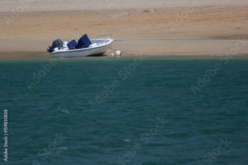 Small motorboat moored on a beach