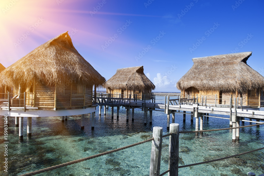 Polynesian landscape -small houses on water Polynesian landscape -small houses on water