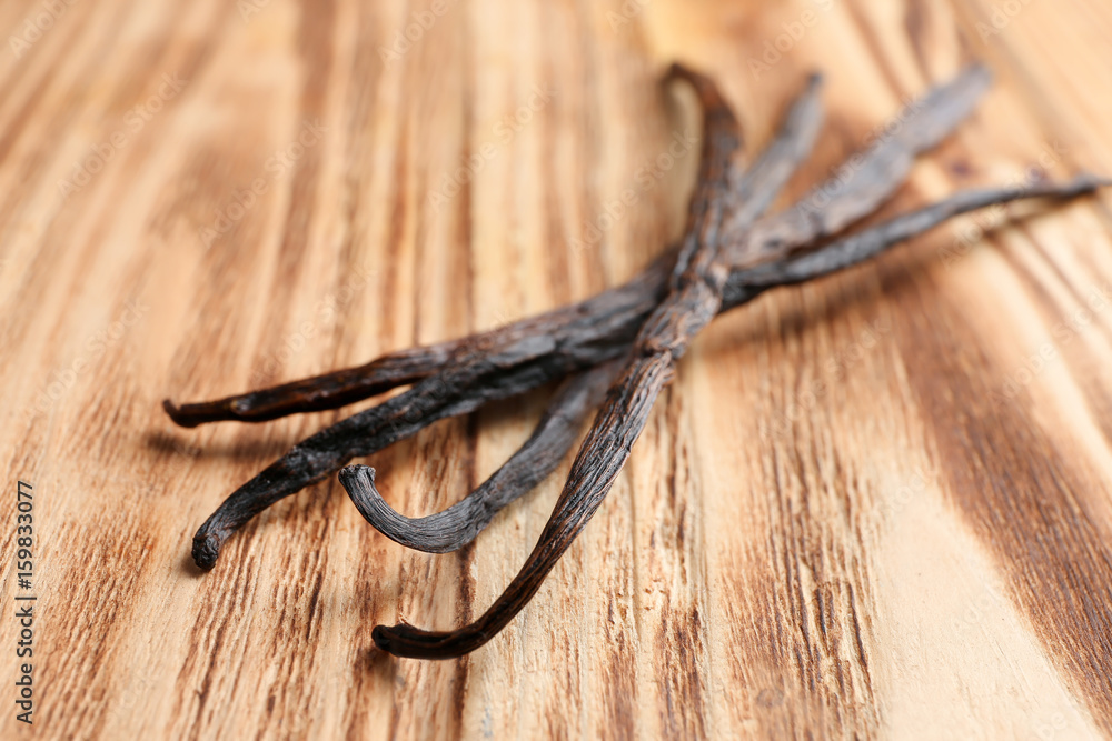 Dried vanilla sticks on wooden background, closeup Dried vanilla sticks on wooden background, closeup