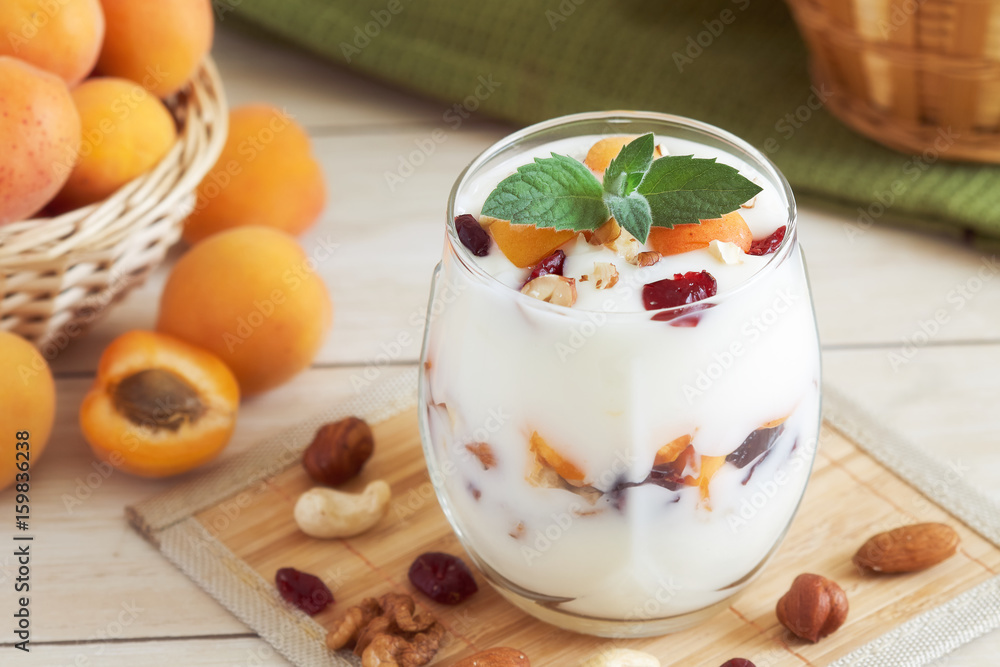 Apricot yogurt dessert served with various nuts and fresh apricots Apricot yogurt dessert served with various nuts and fresh apricots
