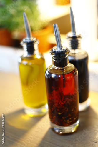 bottles of oil and vinegar on a wooden table