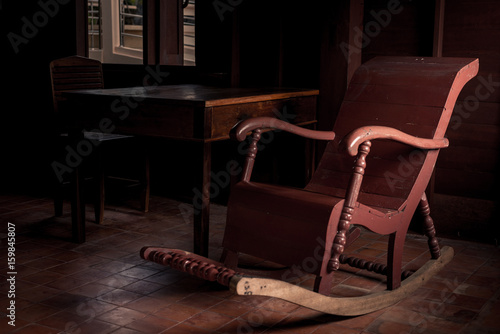 Brown rocking chair and side light © apisit