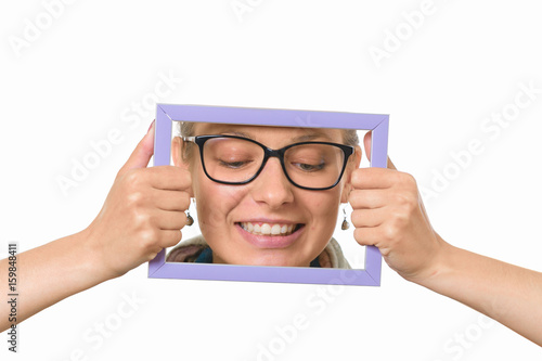 Beautiful girl in a picture frame on a white background.