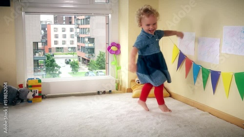 Wicked kid at home. Active girl run jump and dance with energy