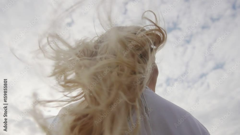 Blonde hair with curls shaking behind her back during gait of a young woman. Beautiful, well maintained, painted, stacked hair long hair. Blonde hair with curls shaking behind her back during gait of a young woman. Beautiful, well maintained, painted, stacked hair long hair.