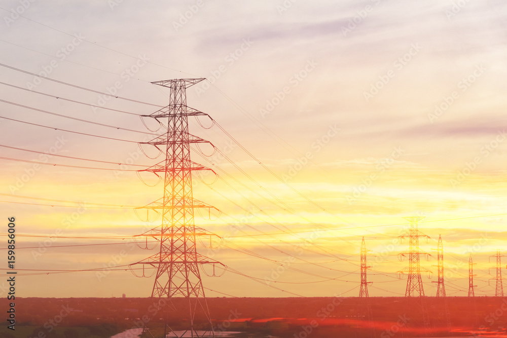 Abstract scene of silhouette electric pylon with the twilight sky before the sun set.The elctric power concept.