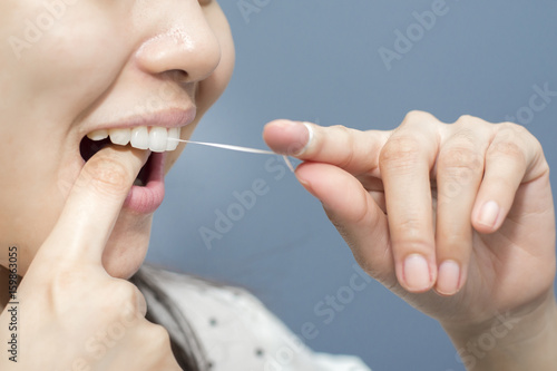 Smiling women use dental floss white healthy teeth