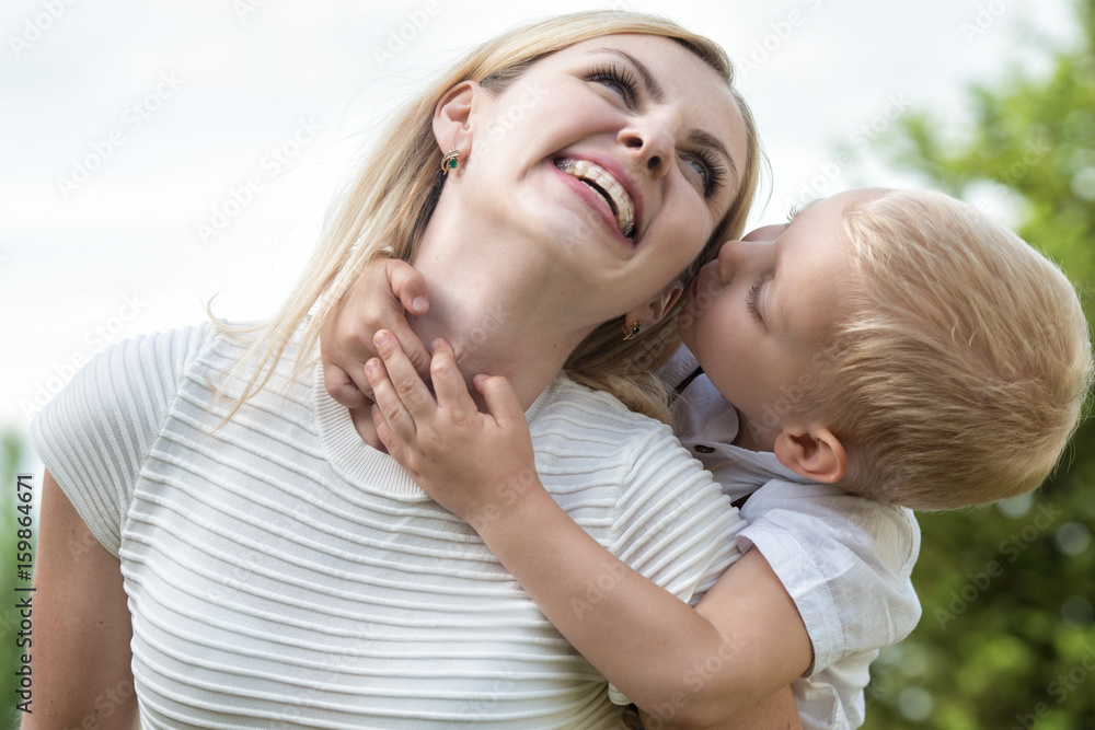 Life moment of happy family!Little boy tenderly embraces his mother. Life moment of happy family!Little boy tenderly embraces his mother.