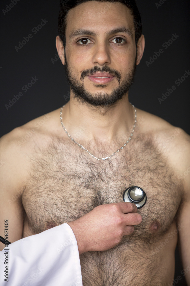 doctor with stethoscope listening to shirtless patients heartbeat Stock Photo Adobe Stock