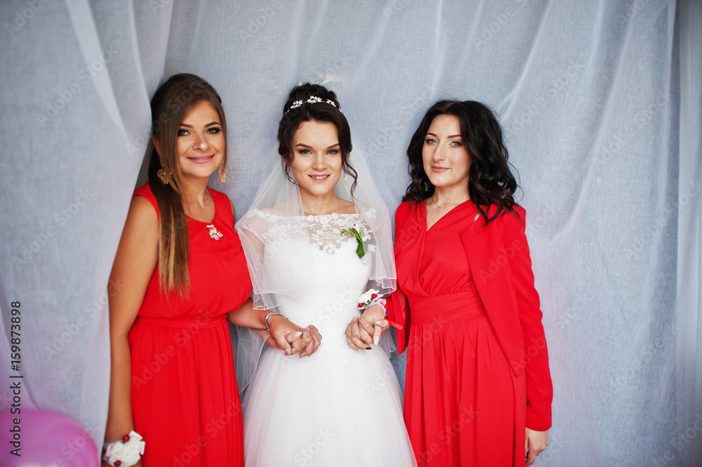 Gorgeous bride with her perfect braidsmaids in her room smiling and discussing wedding. Gorgeous bride with her perfect braidsmaids in her room smiling and discussing wedding.