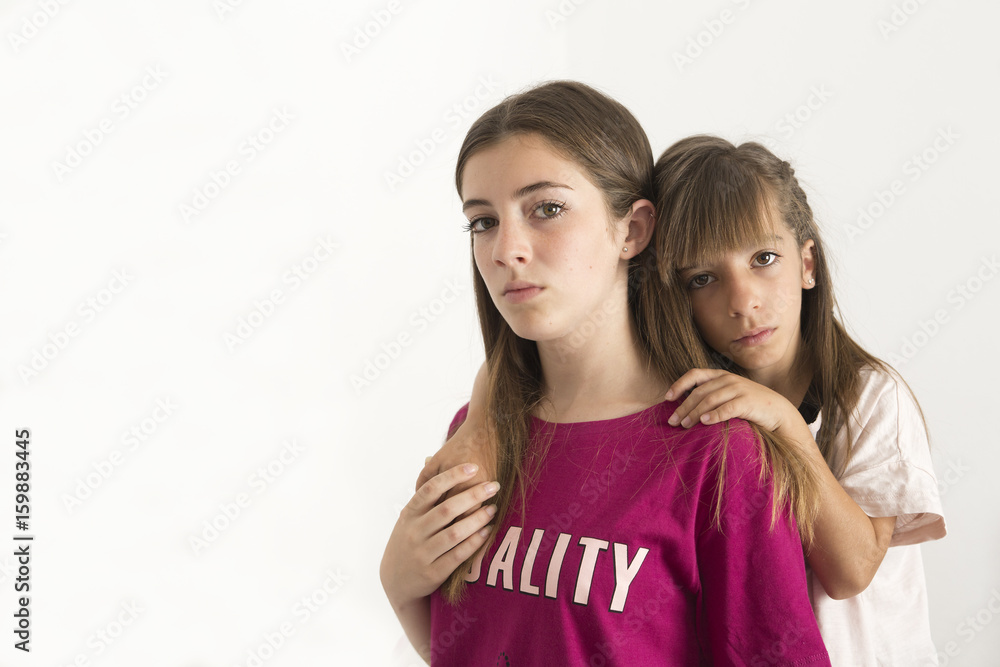 Portrait of two 15 and 10 year old sisters. Portrait of two 15 and 10 year old sisters.