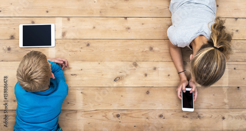 Obraz na płótnie boy and girl using mobile technology header image