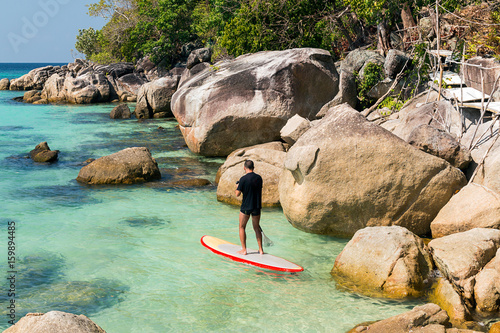 Man practicing paddle surf on Ko Lipe island, Thailand