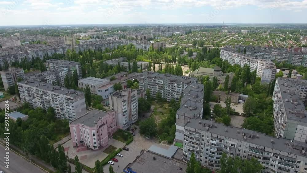 Unusual view on Kherson city in Ukraine from bird`s eye perspective with multistoreyed apartment blocks, green streets, in a sunny day in summer. The cityscape and skyscape look fine Unusual view on Kherson city in Ukraine from bird`s eye perspective with multistoreyed apartment blocks, green streets, in a sunny day in summer. The cityscape and skyscape look fine