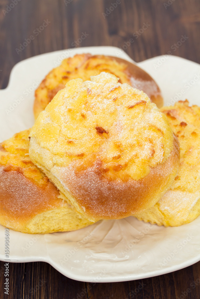 typical portuguese buns with coconut on white plate typical portuguese buns with coconut on white plate