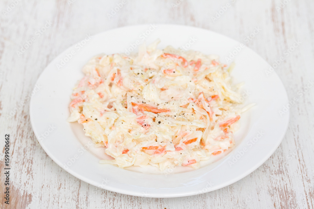 cabbage salad on white plate on wooden background cabbage salad on white plate on wooden background