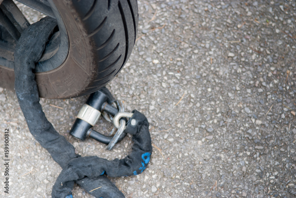 Fototapeta premium motorcycle locked with a chain to prevent theft