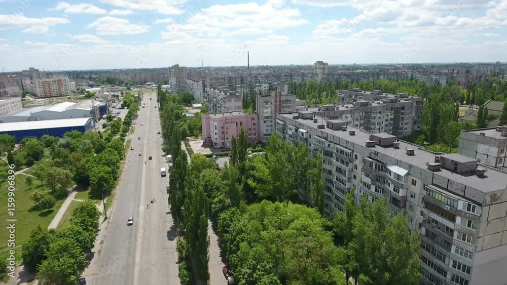 Original view on Kherson city in Ukraine from bird`s eye perspective with multistoreyed apartment blocks, green parks, big and wide street, in a sunny day in summer. The cityscape looks fine Original view on Kherson city in Ukraine from bird`s eye perspective with multistoreyed apartment blocks, green parks, big and wide street, in a sunny day in summer. The cityscape looks fine