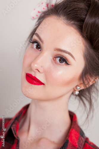 beautiful young woman on white background in old fashion clothes representing pinup and retro style