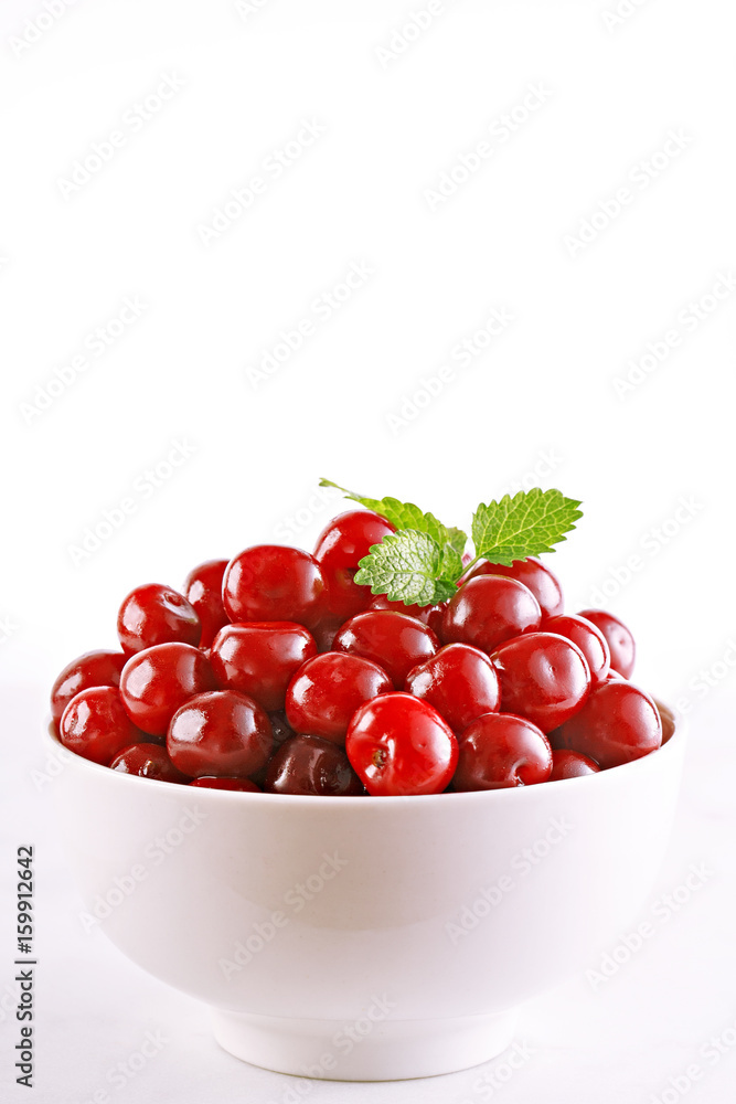 Sour cherries in a bowl isolated on white background. Fresh fruit. Sour cherries in a bowl isolated on white background. Fresh fruit.