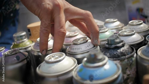 Graffiti writer's hand picking color spray can