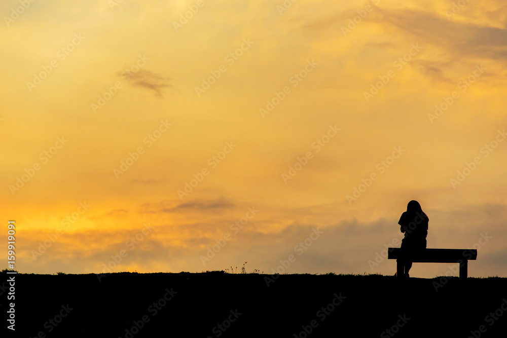 silhouette of woman relax on chair happy time sunset