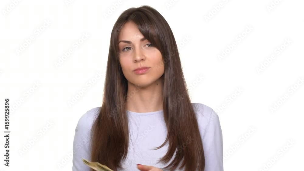 Young successful brunette Caucasian lady counting dollars and smiling over white background Young successful brunette Caucasian lady counting dollars and smiling over white background
