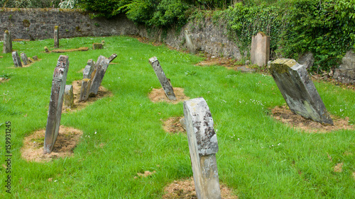 Derelict country graveyard with old headstones